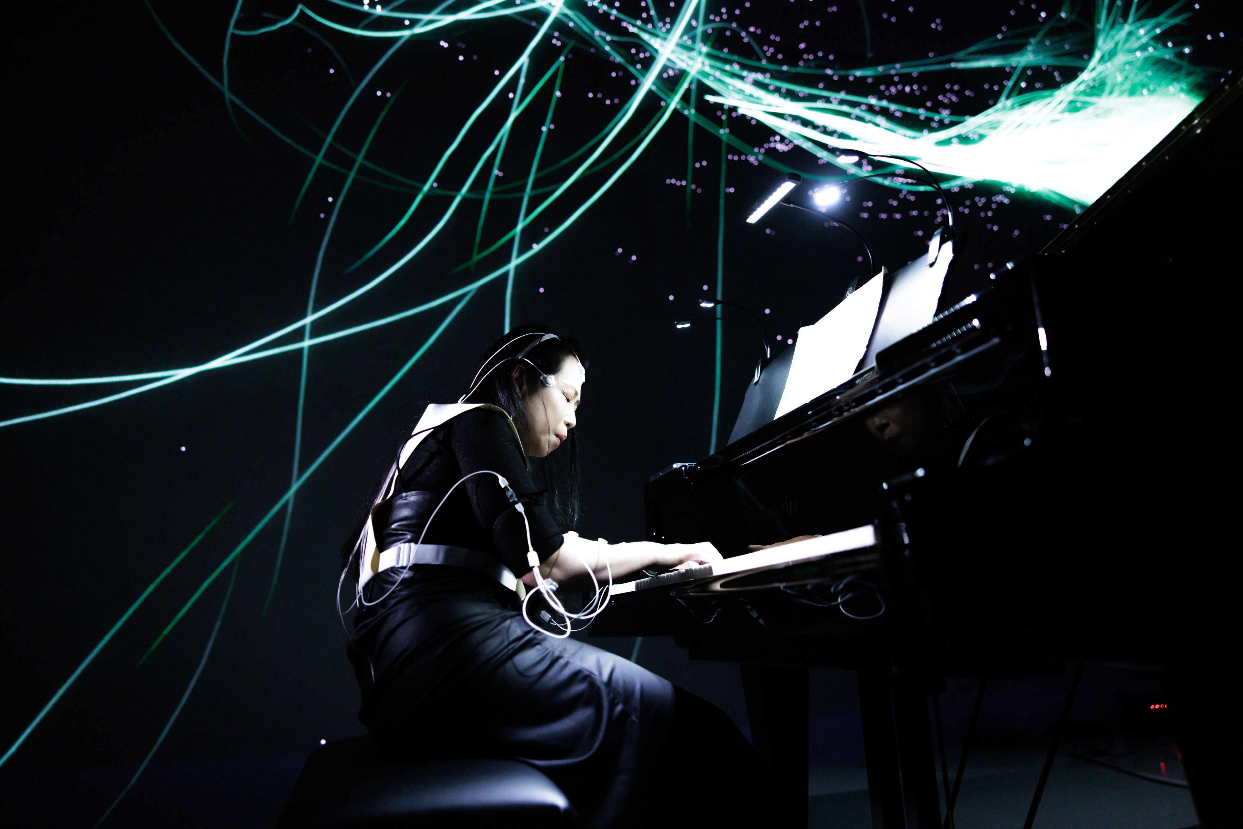 Picture of pianist Maki Namekawa playing during the Life Ink premiere